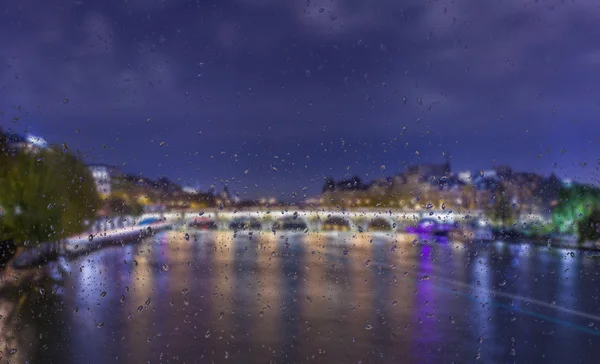 Abstract blurry background with water drops: view through the window Paris by night France — Stock Photo, Image