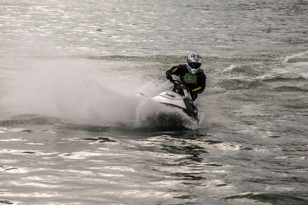 Sistiana, italien - 22. april 2012: mann auf jet ski schwingt mit viel spritzern — Stockfoto