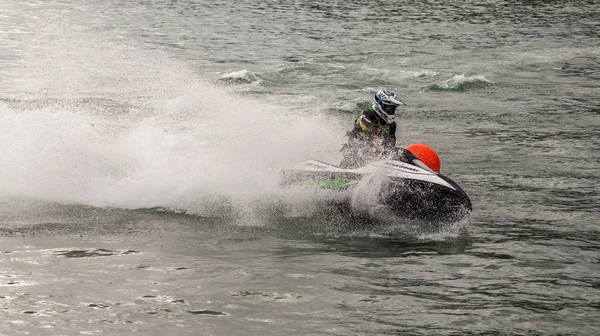 Sistiana, Italy - April 22, 2012: Man on jet ski turns with much splashes — Stock Photo, Image