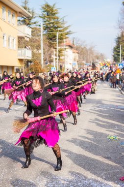 Festival, the parade of carnival floats with dancing people on streets of Opicina