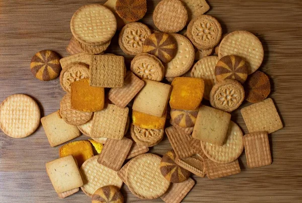 different types of wheat biscuits mixed also called food cracker famous as chai biscuit in india and pakistan served with tea mostly displayed on brown background, selective focus