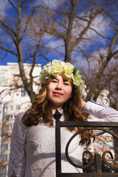 Beautiful young girl with a floral ornament in her hair — Stock Photo, Image