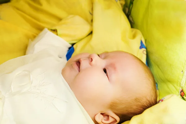 Šťastný roztomilý 4 měsíční dítě ležící na posteli — Stock fotografie