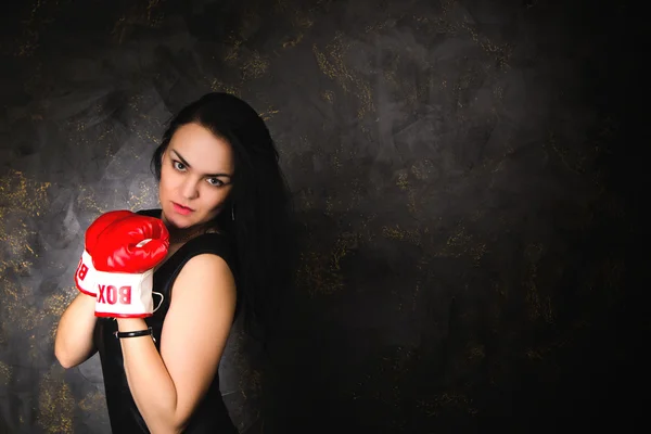 Sexy young brunette model posing in boxing gloves — Stock Photo, Image