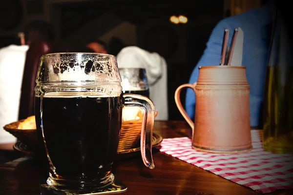 Glass of dark beer in a restaurant — Stock Photo, Image