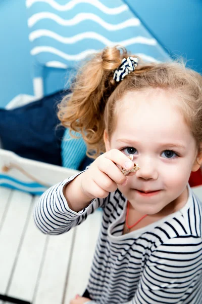 Belle petite fille près de la mer décorations tient coquille de mer — Photo