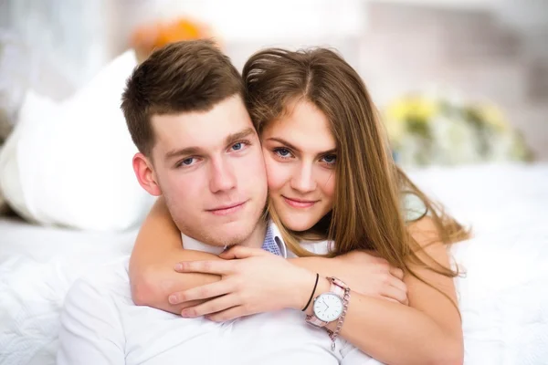 Happy girl in love at home embracing boyfriend — Stock Photo, Image
