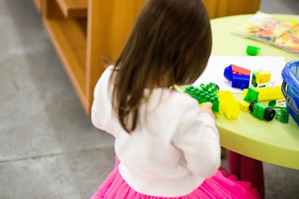 Charming preschooler playing with small constructor — Stock Photo, Image