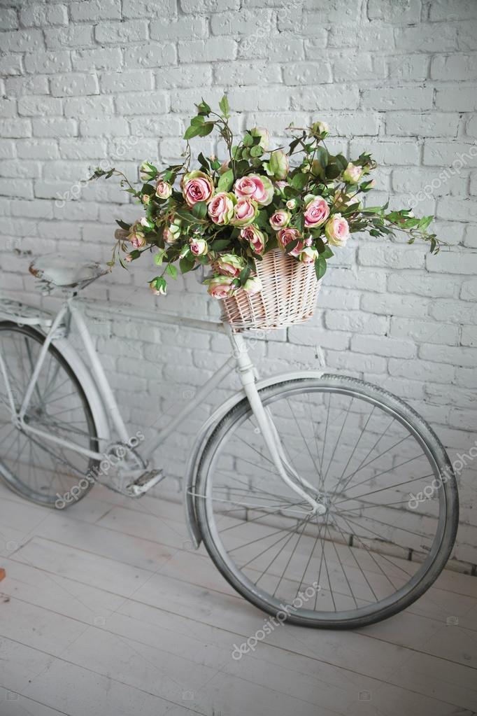 Old bicycle and flowers close to the white brick wall — Stock