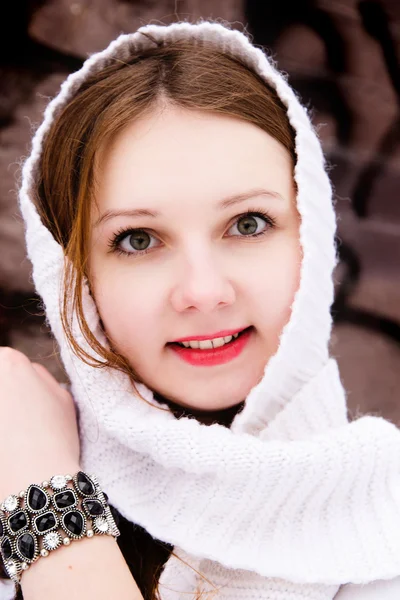 Feminine girl in a white scarf over a stone wall — Stock Photo, Image