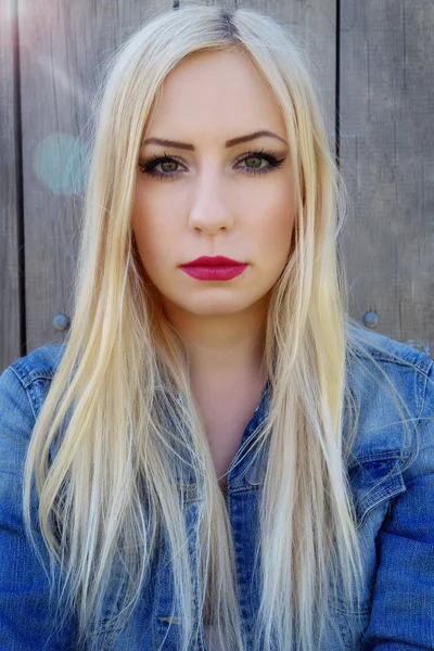 Portrait of a girl with blond hair and a denim jacket — Stock Photo, Image