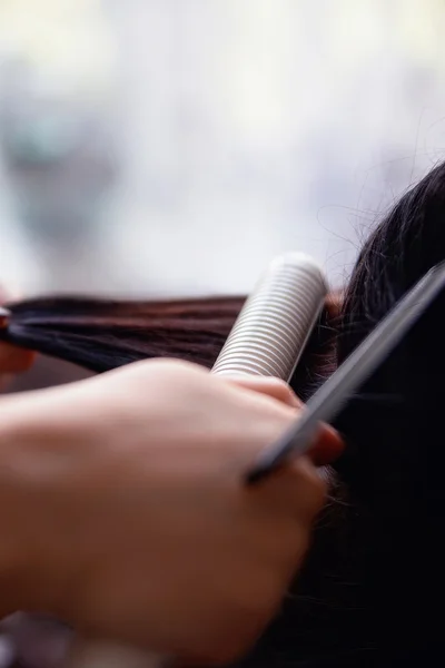 Barber uses a hair iron — Stock Photo, Image