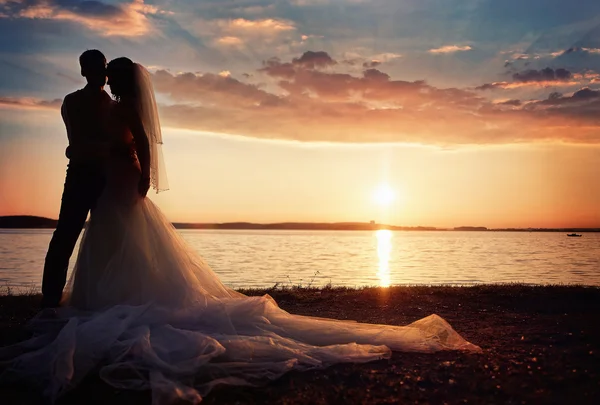 Невеста и жених вместе на фоне заката — стоковое фото