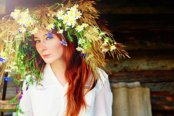 Beautiful happy girl in a flower wreath — Stock Photo, Image