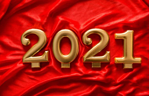 Golden numbers 2021 on a silk background. The concept of the coming new year — Stock Photo, Image