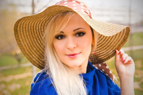 Beautiful young blond woman with long hair in  hat — Stock Photo, Image