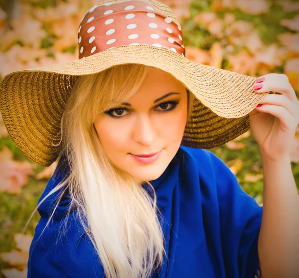 Beautiful young blond woman with long hair in  hat — Stock Photo, Image