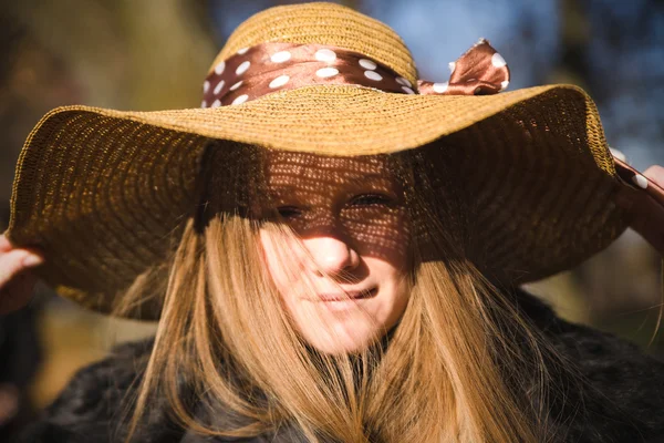 Beautiful young brunette woman with long hair in hat — Stock Photo, Image