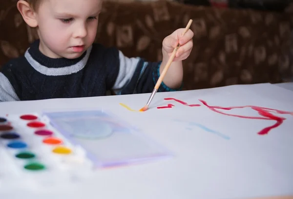 Cute little boy painting with brush — Stock Photo, Image