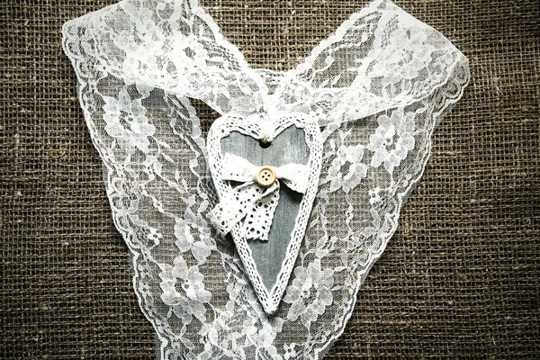wooden  hearts  and lace on a background of burlap