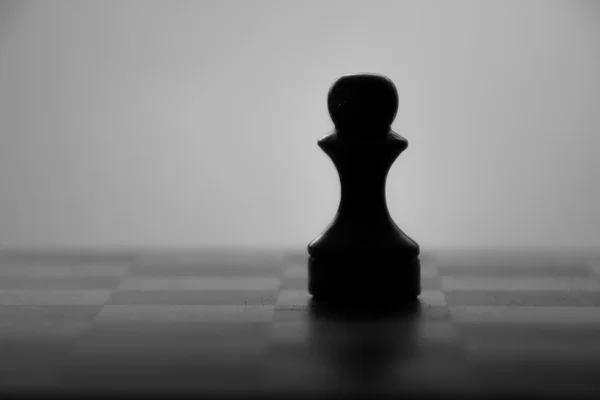 Wooden chess board and chess piece black silhouette — Stock Photo, Image