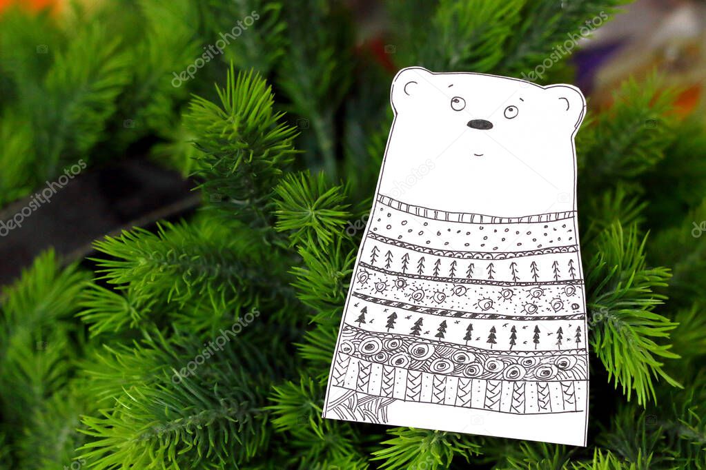 Cut out of paper bear figurine painted with patterns in doodling style. Paper figure bears. New Year decorations.