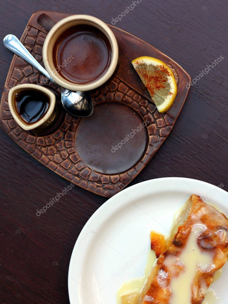 Strudel and coffee cup top view on wooden table