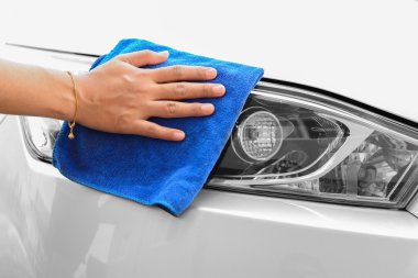 Hand with microfiber cloth cleaning car clipart