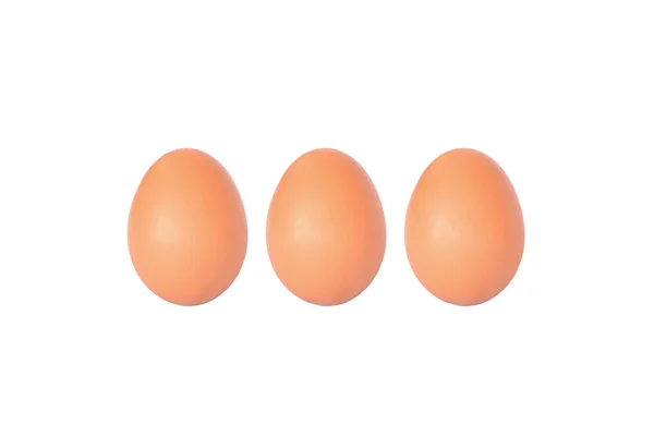 Tre bruna kyckling ägg på vitt tyg bakgrund med kopia spa — Stockfoto
