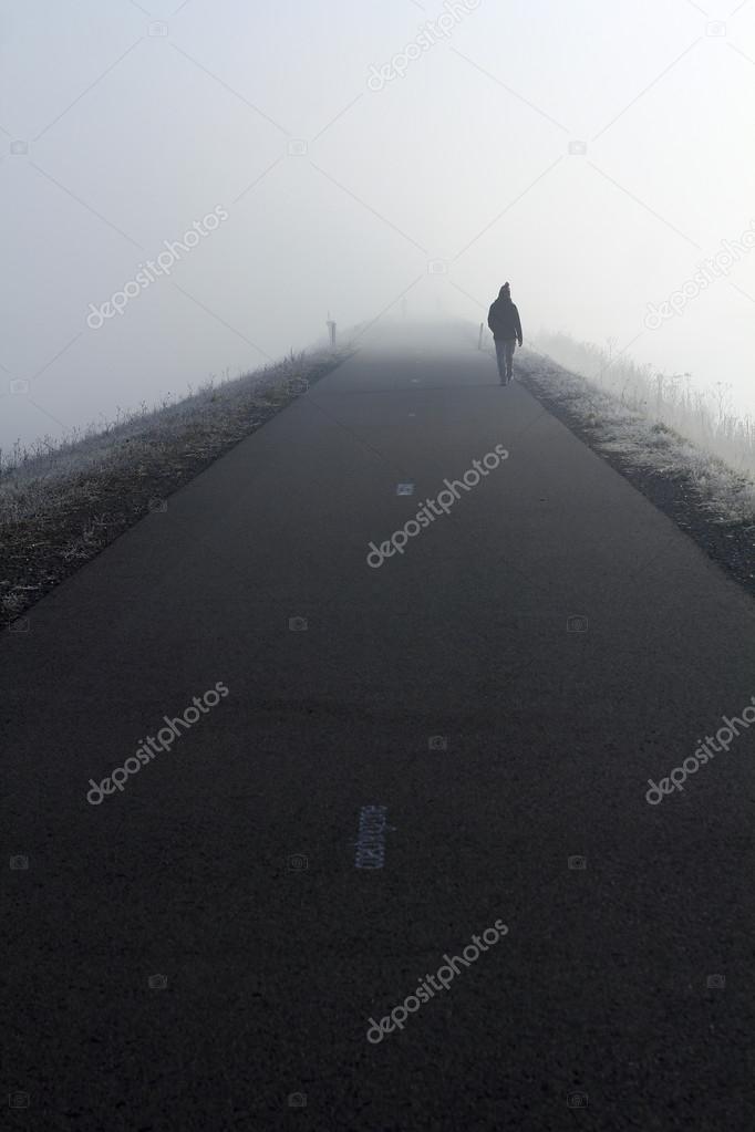 Person walking into the fog