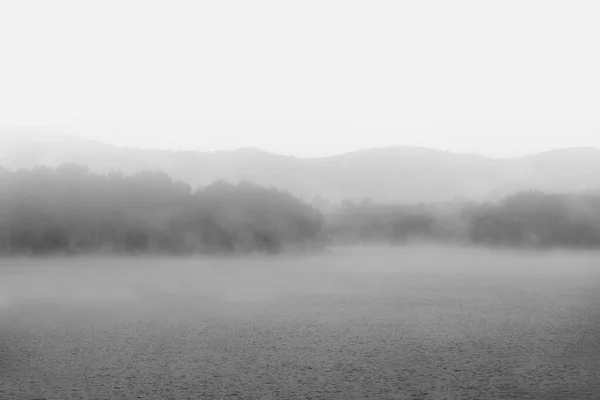 Fog in the dam reservoir in black and white, Spain