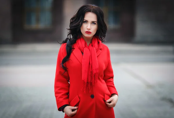 Beautiful woman in a red coat — Stock Photo, Image