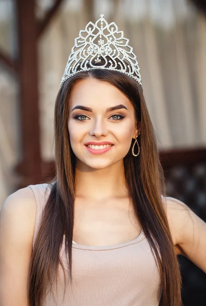 Beautiful woman with crown on a head smiling