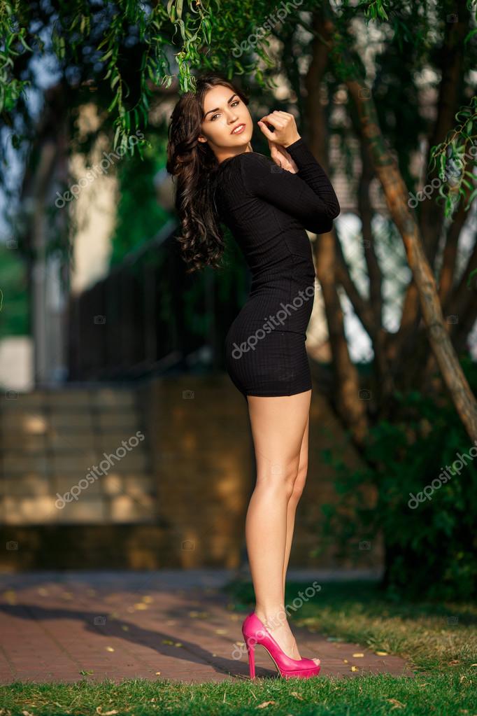 Beautiful girl in a sexy short dress outdoor Stock Photo by ©dens22us@rambler.ru 119401252