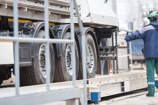 Men and Tanker Truck In Industrial Plant.