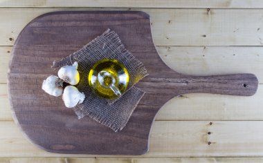 Garlic and Olive Oil on Rustic Board clipart