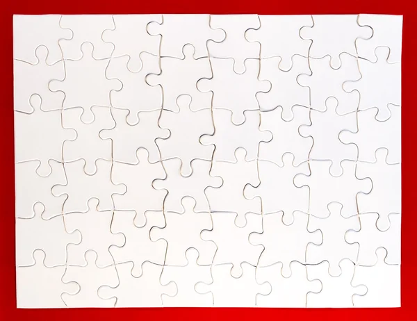 Completed White Jigsaw Puzzle on Red Background — Stock Photo, Image