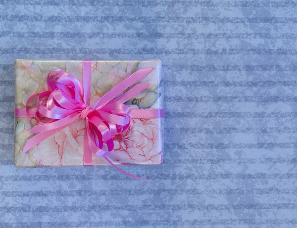 Feminine Wrapped Gift on Lilac Background