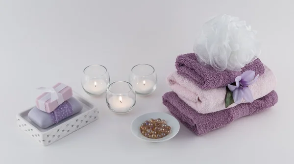 Luxury Soap, Bath Oil Beads, and Towels with Lit Candles