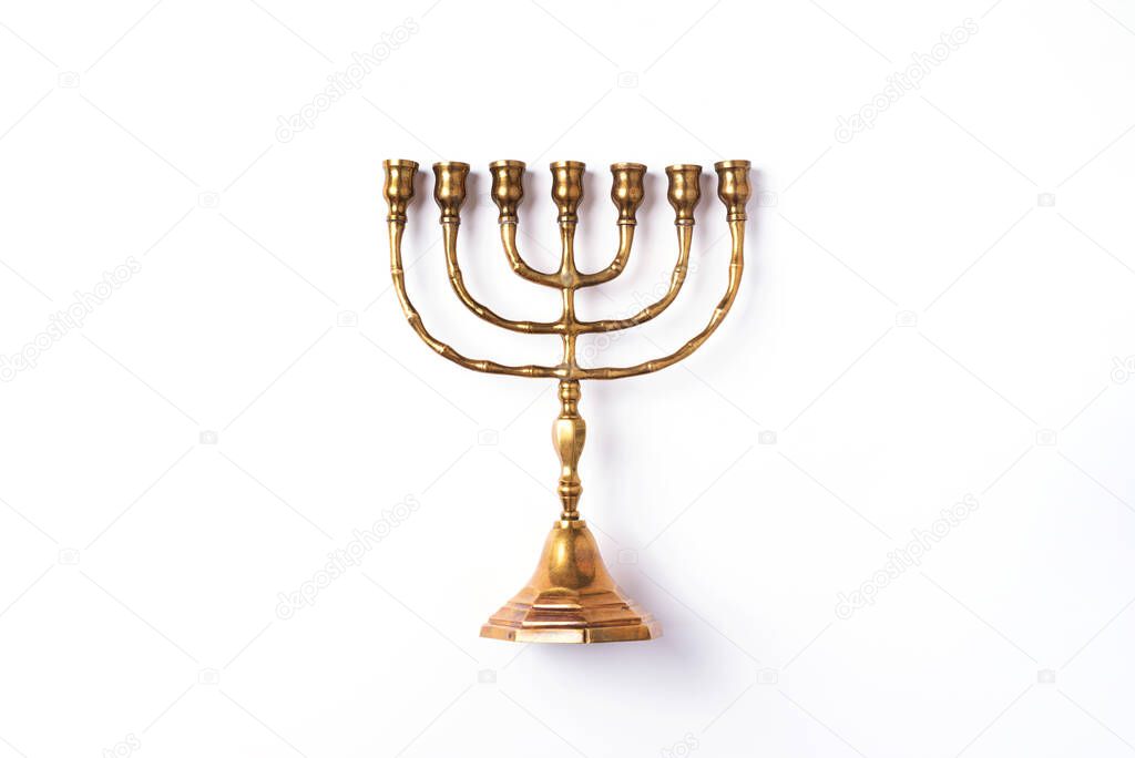 Golden hanukkah menorah on isolated on white background. Jewish holiday banner with copy space. Ancient ritual religious candle menorah.