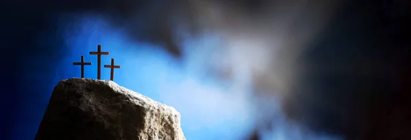 Crucifixion, resurrection of Jesus Christ. Three crosses against blue sky on Calvary hill background. Christian Easter holiday, Golgotha. He risen and alive. Jesus is the reason. Gospel, salvation.