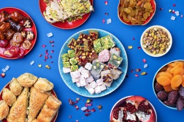 Geleneksel Türk zevki mavi arka planda. Üst Manzara. Düz yatıyordu. Uzayı kopyala Arap tatlısı, baklava, halva, rahat lokum, şerbet, fındık, fıstık, hurma, kuru üzüm, kayısı, kilise kilisesi.