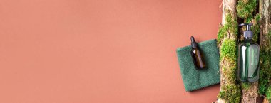 Yeşil cam şampuan, sabun, kahverengi arka planda saç kremi ve ağaç kabuğunun üstünde doğal yosun. Üst görünüm, boşluğu kopyala. Model için boş etiket. Cilt bakımı, organik vücut tedavisi, spa konsepti.