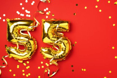 Altın folyo balon numarası, doksan beş. Doğum günü tebrik kartında 95 yazılıydı. Yıldönümü kutlaması. Pankart. Altın rakamlı, kırmızı arkaplan. Sayısal rakam, parlak parlak parıltı.