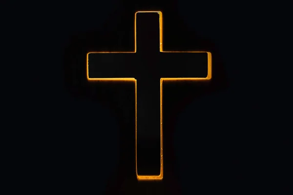 Silhouette of christian cross, lights, bokeh on black background. Copy space. Faith symbol. Church worship, salvation concept. Faith symbol in Jesus Christ. Holy cross for Easter day. Christianity.