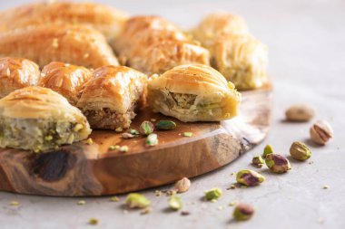 Middle eastern dessert baklava with pistachios on grey background. Copy space. Banner. Turkish delight baklava, traditional eastern arabian sweets.