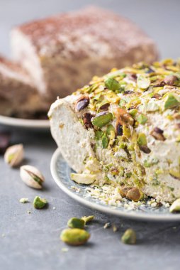 Sesame chocolate halva and halva with pistachios on grey background. Top view. Copy space. Traditional middle eastern sweets. Jewish, turkish, arabic national dessert. Turkish delight.
