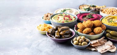 Akdeniz aperatif konsepti. Geleneksel Arap yemekleri. Pide, zeytin, humus, dolma dolma, falafel köftesi, turşu, babaganush, sebze, nar, patlıcan.
