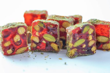 Turkish delight - lokum or rahat lokum with pistachios on grey background. Traditional eastern cuisine. Traditional middle eastern sweets. Jewish, turkish, arabic national dessert. Turkish delight.