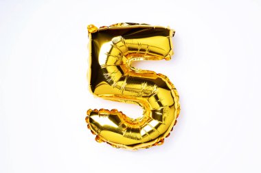 Creative layout. Golden foil balloon number and digit five 5. Birthday greeting card. Anniversary concept. Top view. Copy space. Stylish gold numeral over white background. Numerical digit